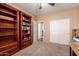 Bedroom with built-in bookcases and a walk-in closet, offering ample storage space at 6963 W Aurora Dr, Glendale, AZ 85308