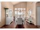 Inviting dining room with vaulted ceilings, wood floors, and lots of natural light at 6963 W Aurora Dr, Glendale, AZ 85308