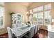 Bright dining area with wood floors, vaulted ceiling, shutters, and modern decor at 6963 W Aurora Dr, Glendale, AZ 85308