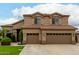 Lovely two-story home featuring a three-car garage and desert landscaping at 6963 W Aurora Dr, Glendale, AZ 85308