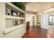 Hallway with built-in display shelves showcasing decorations, books, and a glimpse of another room at 6963 W Aurora Dr, Glendale, AZ 85308