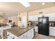 Open kitchen with granite countertops, stainless steel appliances, and a center island at 6963 W Aurora Dr, Glendale, AZ 85308