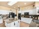 Bright kitchen featuring granite countertops, white cabinets, and stainless steel appliances at 6963 W Aurora Dr, Glendale, AZ 85308