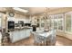 Eat-in kitchen offers modern appliances and a dining area with elegant chandelier and backyard views at 6963 W Aurora Dr, Glendale, AZ 85308