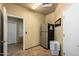 Functional laundry room with tiled floors, a refrigerator, and convenient access to other areas at 6963 W Aurora Dr, Glendale, AZ 85308