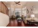 Bright living room featuring hardwood floors, a ceiling fan, and many windows with shutters at 6963 W Aurora Dr, Glendale, AZ 85308