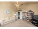Cozy living room with plush carpeting, a ceiling fan, and a view of another room at 6963 W Aurora Dr, Glendale, AZ 85308