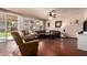Spacious living room with hardwood floors, comfortable seating, and natural light at 6963 W Aurora Dr, Glendale, AZ 85308