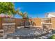 Charming patio area featuring an outdoor dining set and decorative planters at 6963 W Aurora Dr, Glendale, AZ 85308