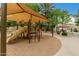 Community playground with slides, picnic tables, and shade structure surrounded by a paved path at 6963 W Aurora Dr, Glendale, AZ 85308