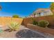 Low-maintenance side yard with desert landscaping and privacy wall at 6963 W Aurora Dr, Glendale, AZ 85308