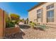 Spacious side yard with gravel groundcover, landscaping, and home exterior at 6963 W Aurora Dr, Glendale, AZ 85308