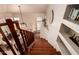 View from the top of the hardwood staircase with a landing and views of the living area at 6963 W Aurora Dr, Glendale, AZ 85308