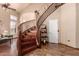 Elegant curved staircase with wood treads and white risers, flooded with natural light at 6963 W Aurora Dr, Glendale, AZ 85308