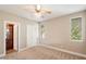 Bedroom with a ceiling fan, neutral paint, carpet, and multiple windows for natural light at 7009 E Acoma Dr # 2134, Scottsdale, AZ 85254