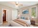 Bright bedroom with a ceiling fan, natural light, and a view of the en suite bathroom at 7009 E Acoma Dr # 2134, Scottsdale, AZ 85254