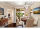 Charming dining room boasts a modern chandelier and sliding door access to the patio at 7009 E Acoma Dr # 2134, Scottsdale, AZ 85254
