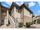 Multi-story condo building with private outdoor stairs, stone accents, and lush greenery at 7009 E Acoma Dr # 2134, Scottsdale, AZ 85254