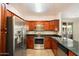 Well-equipped kitchen featuring stainless steel appliances, granite countertops, and wood cabinetry at 7009 E Acoma Dr # 2134, Scottsdale, AZ 85254