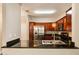 Modern kitchen with stainless steel appliances, granite countertops, and rich wood cabinetry at 7009 E Acoma Dr # 2134, Scottsdale, AZ 85254