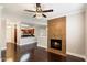 Bright living room with fireplace and hardwood floors; stylish ceiling fan and light fixture add charm at 7009 E Acoma Dr # 2134, Scottsdale, AZ 85254