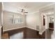 Sunlit living room with hardwood floors, a stylish ceiling fan, and a view of the kitchen at 7009 E Acoma Dr # 2134, Scottsdale, AZ 85254