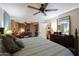 Spacious bedroom with a ceiling fan, ensuite office, and a cozy sitting area at 7138 W Sierra Vista W Dr, Glendale, AZ 85303
