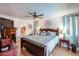Comfortable main bedroom with a ceiling fan, ensuite bathroom, and neutral décor at 7138 W Sierra Vista W Dr, Glendale, AZ 85303
