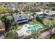 A beautiful home boasts a private backyard with a refreshing pool, outdoor seating, and meticulous landscaping at 726 W El Camino W Dr, Phoenix, AZ 85021