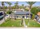 Two-story home boasting mature trees, green lawn and mountain views at 726 W El Camino W Dr, Phoenix, AZ 85021