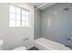 Modern bathroom features gray subway tile shower, window and white fixtures at 726 W El Camino W Dr, Phoenix, AZ 85021