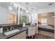 Elegant bathroom vanity with luxurious mirrors, crystal lighting, and a view into bedroom at 726 W El Camino W Dr, Phoenix, AZ 85021