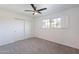 Bright bedroom with carpet flooring, a ceiling fan, and a window offering natural light and outdoor views at 726 W El Camino W Dr, Phoenix, AZ 85021