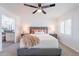 Comfortable bedroom featuring a ceiling fan, a large bed, and shuttered windows at 726 W El Camino W Dr, Phoenix, AZ 85021