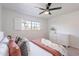 Cozy bedroom bathed in natural light, showcasing a ceiling fan and white shuttered windows at 726 W El Camino W Dr, Phoenix, AZ 85021