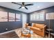 Inviting bedroom with a leather sofa, stylish decor, and a ceiling fan for added comfort at 726 W El Camino W Dr, Phoenix, AZ 85021