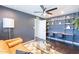 Functional bedroom with a modern desk, shelving, and comfortable seating for work or relaxation at 726 W El Camino W Dr, Phoenix, AZ 85021
