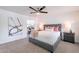 Serene bedroom with a large painting, plush bed, and view into an ensuite vanity at 726 W El Camino W Dr, Phoenix, AZ 85021