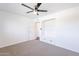 Neutral bedroom features a ceiling fan, carpeted floors, and built-in shelving niche for storage at 726 W El Camino W Dr, Phoenix, AZ 85021