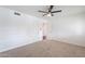 Carpeted bedroom featuring a ceiling fan, carpeted floors, and a double door entrance at 726 W El Camino W Dr, Phoenix, AZ 85021