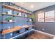Stylish bedroom featuring a built-in desk, open shelving, and modern decor for a functional workspace at 726 W El Camino W Dr, Phoenix, AZ 85021