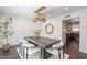 Dining area featuring a wood table, stylish lighting, and white accent wall at 726 W El Camino W Dr, Phoenix, AZ 85021