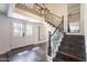 Elegant foyer with dark wood floors, staircase, and chandelier at 726 W El Camino W Dr, Phoenix, AZ 85021