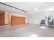 Clean and organized garage space with storage cabinets, utility closet, and access door, ready for your vehicles at 726 W El Camino W Dr, Phoenix, AZ 85021