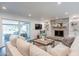 Inviting living room with a brick fireplace, plush seating, and a sliding glass door to the outdoor area at 726 W El Camino W Dr, Phoenix, AZ 85021