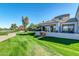 Lush backyard with green lawn, mature trees, and stunning golf course views at 7400 E Gainey Club Dr # 123, Scottsdale, AZ 85258