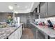 Modern kitchen featuring stainless steel appliances, granite countertops, and gray cabinetry at 7400 E Gainey Club Dr # 123, Scottsdale, AZ 85258