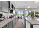 Modern kitchen with stainless steel appliances, granite countertops, and an expansive golf course view at 7400 E Gainey Club Dr # 123, Scottsdale, AZ 85258