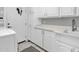 Functional laundry room with white cabinets, countertop space, and a washing machine at 7400 E Gainey Club Dr # 123, Scottsdale, AZ 85258