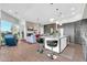 Bright living space connecting to the kitchen, with bar stools and a decorative fireplace at 7400 E Gainey Club Dr # 123, Scottsdale, AZ 85258